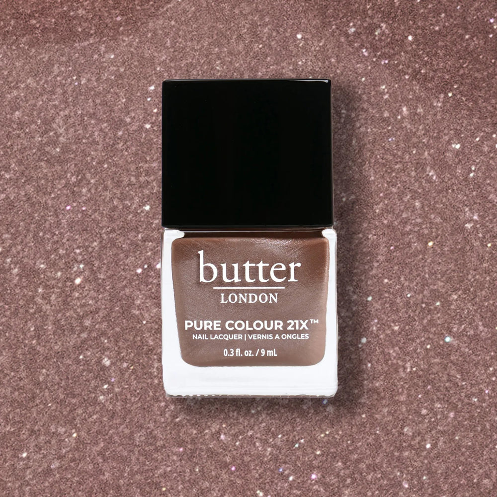 Butter London nail polish bottle on a glittery brown background