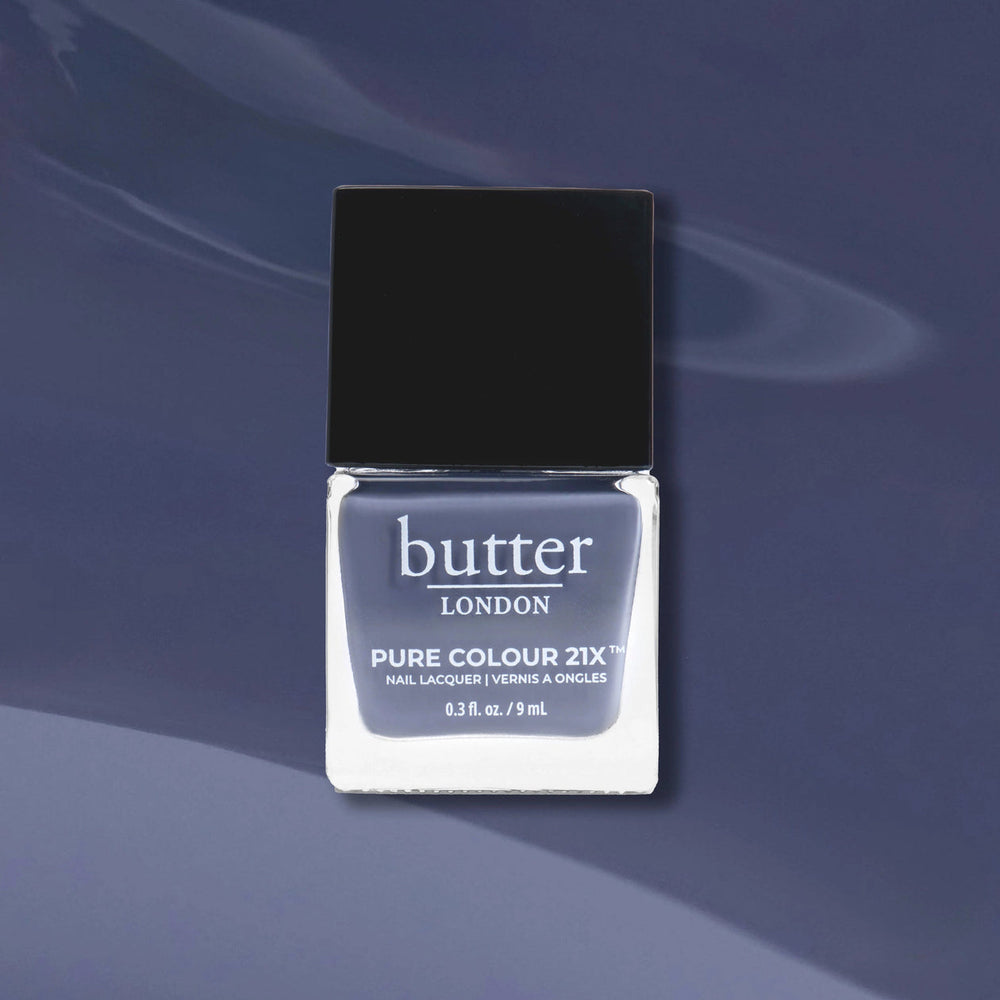 Butter London nail polish bottle on a dark blue background