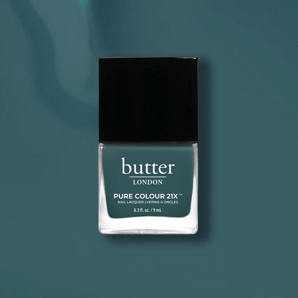 Butter London nail polish bottle on a teal background