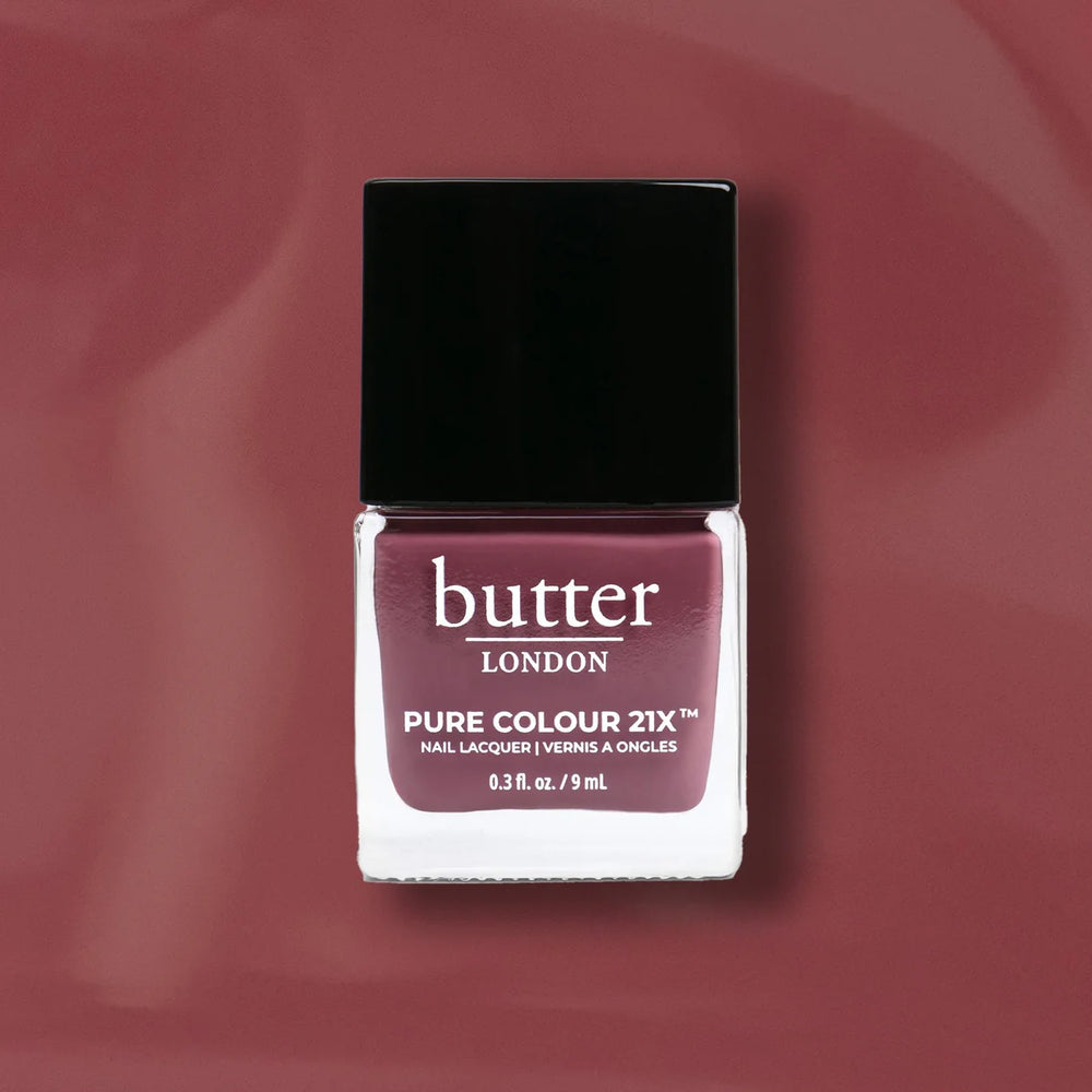 Butter London nail polish bottle on a mauve background