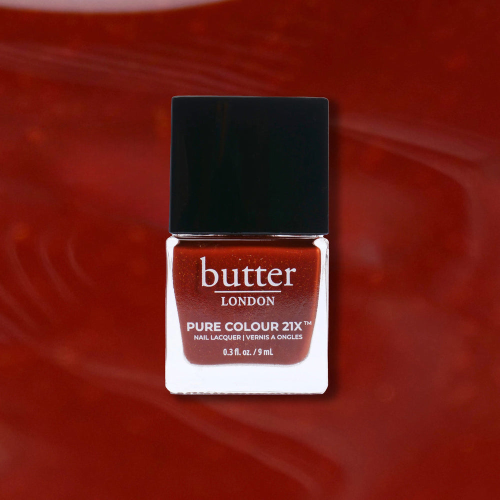 Butter London nail polish bottle on a red background