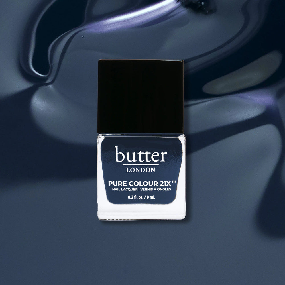 Butter London nail polish bottle on a dark blue background